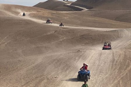 An ATV quad bike driving through the off-road riding desert landscape on an Agafay Quad Marrakech Tour